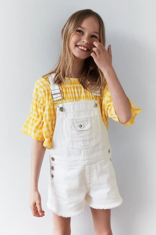 Child in white dress and straw hat