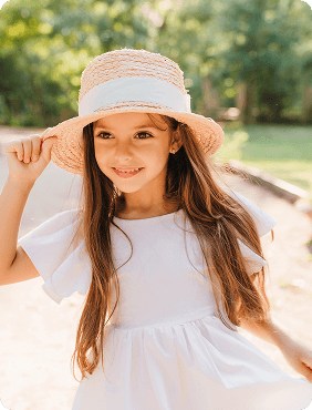 Child in white dress and straw hat